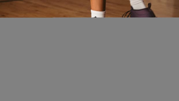 Side view of Candace Parker's purple and white adidas shoes.